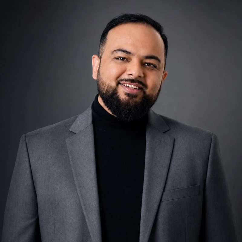 Om Khagram, founder of Three Dots Brands, in a grey blazer and black turtleneck